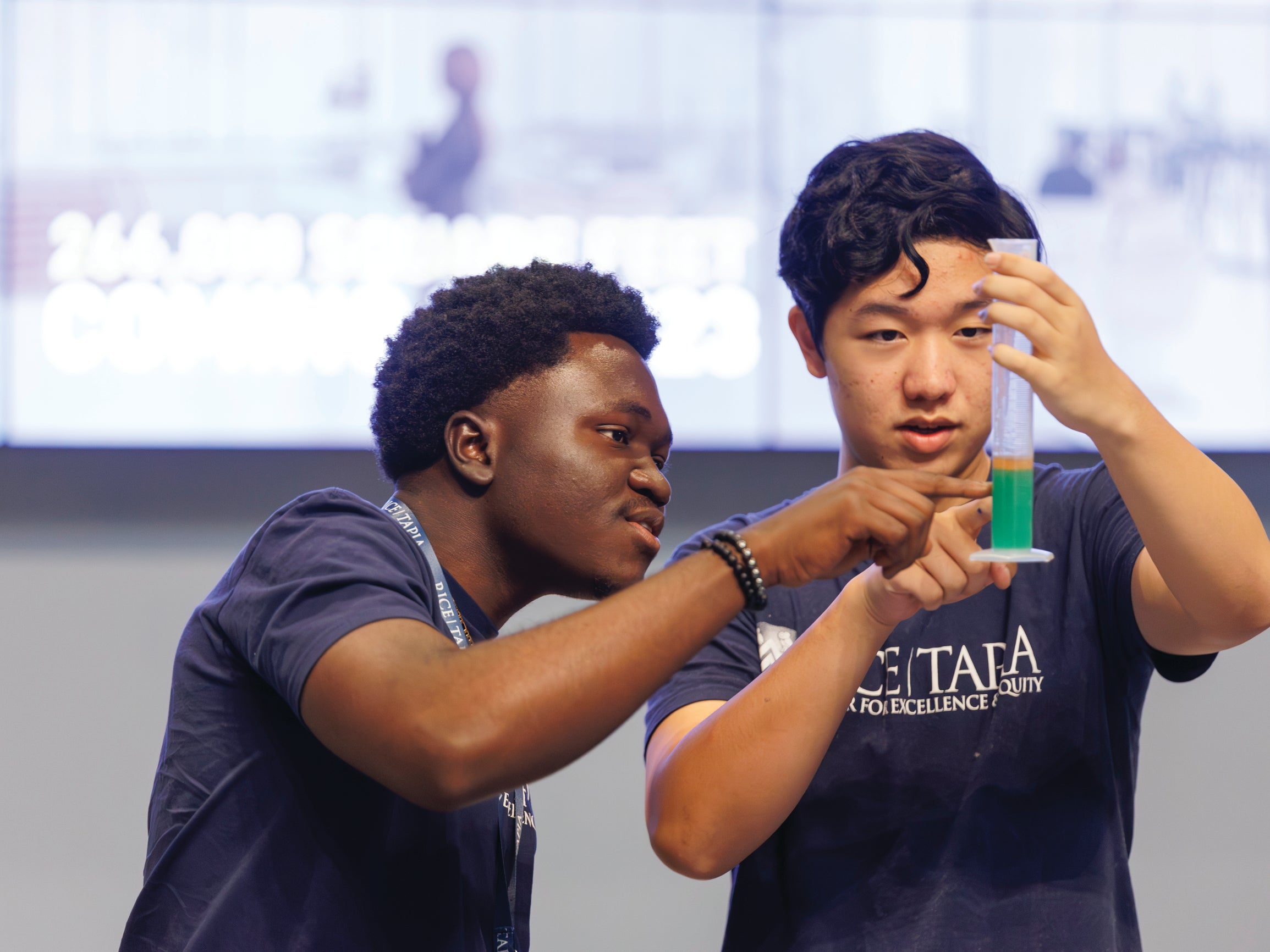 Two campers with educational professional in hands-on activity