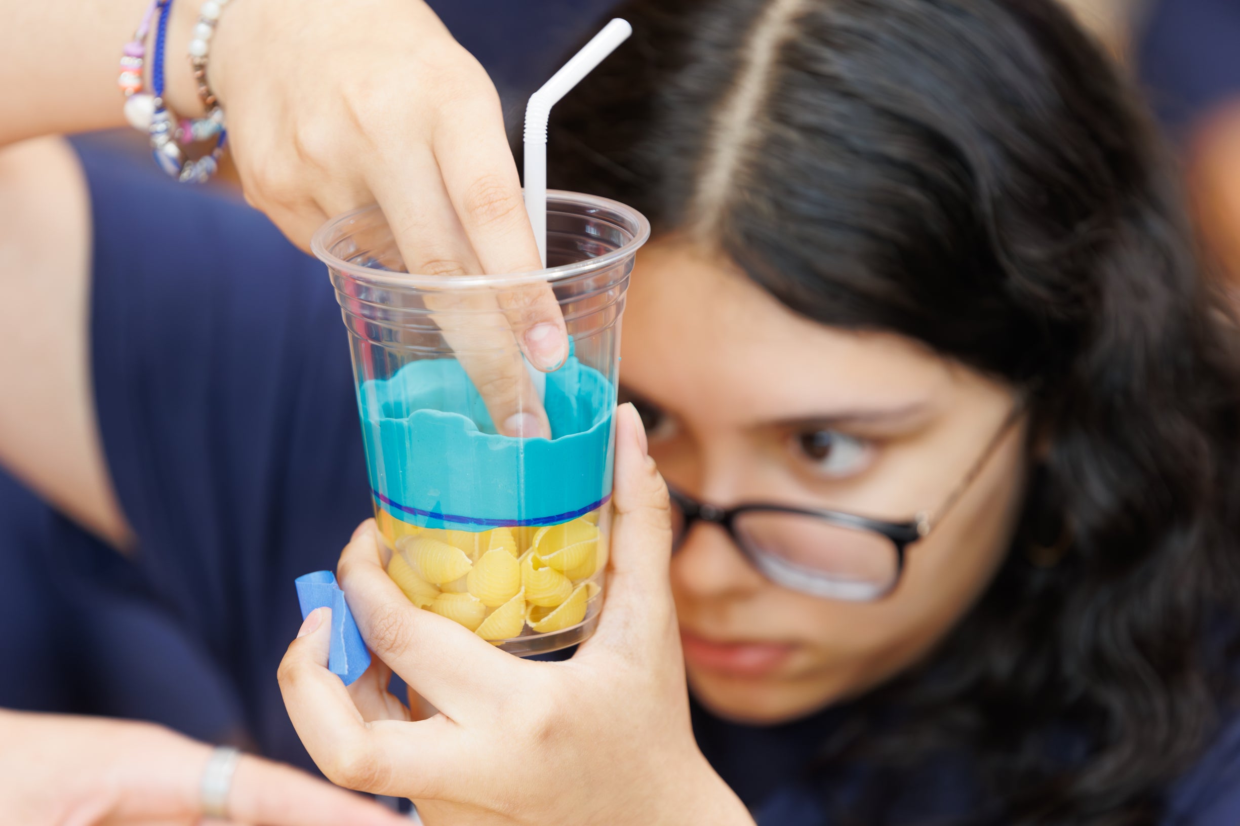 Campers putting Play Doh in their model reservoir
