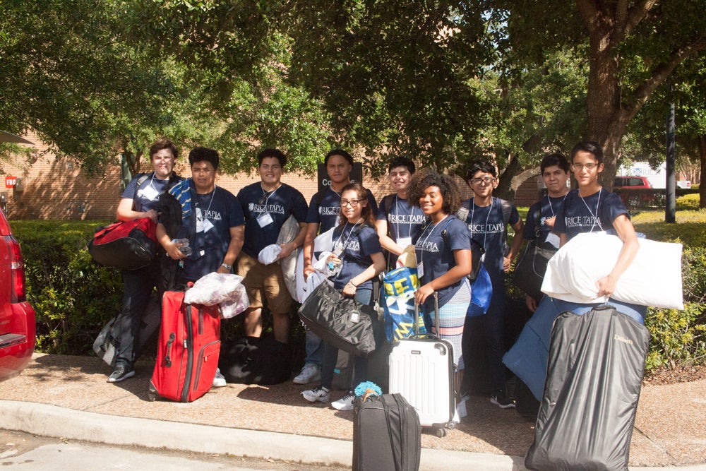 Group of Tapia Campers with luggage on the Rice Campus.