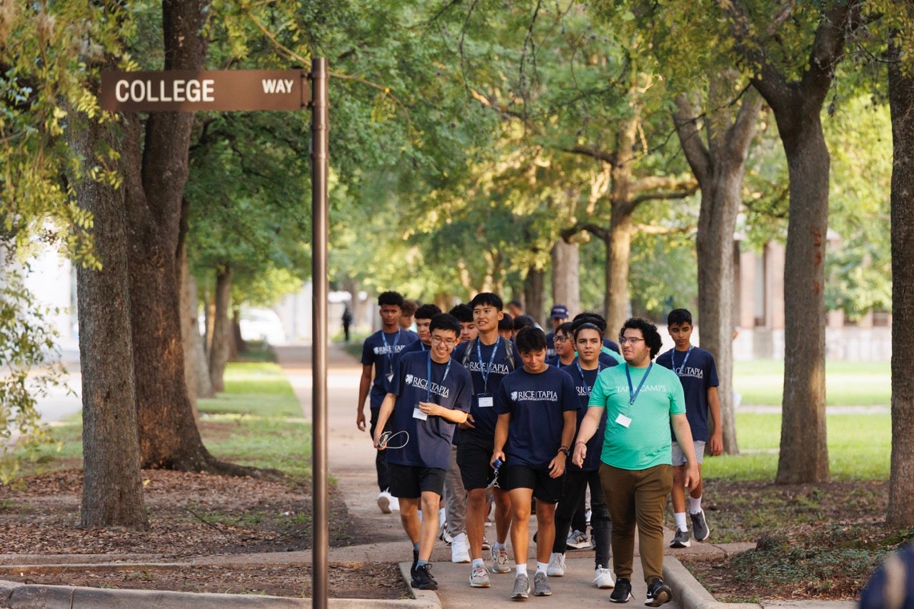 Counselor walking on campus with campers