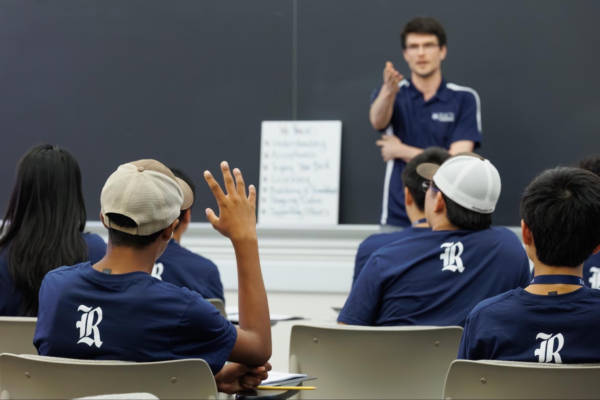 Dr. Hand addressing student with hand raised.