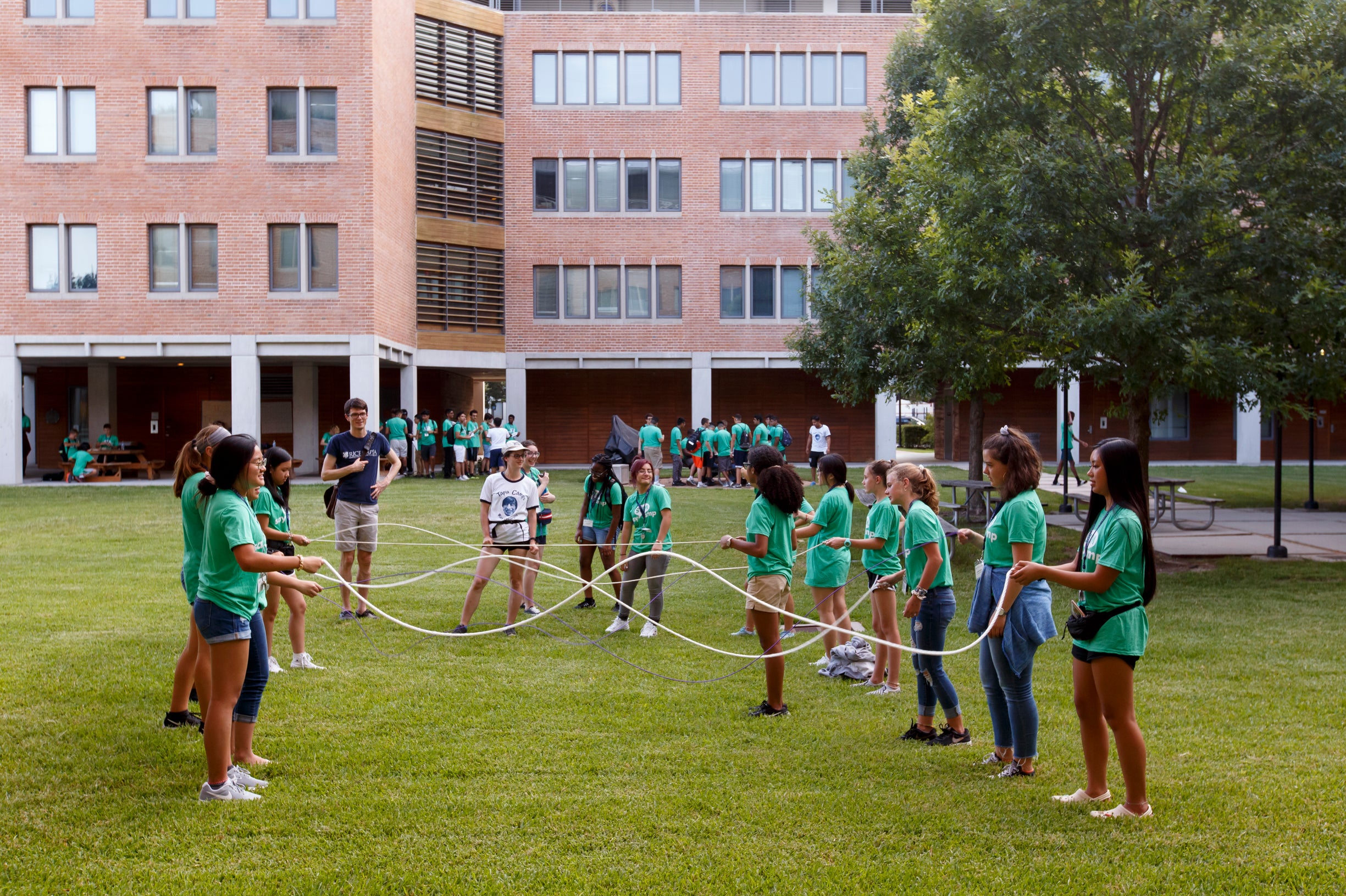 Campers outside of Duncan College completing STEM activity in groups.